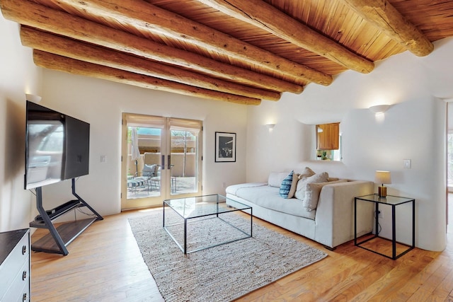 living area featuring wood ceiling, beam ceiling, and light wood finished floors