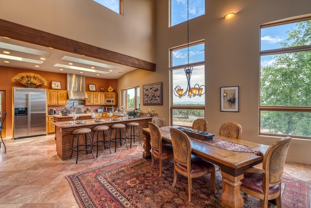 21 Canada Vista Dr, Sandia Park, NM 87047 - dining room with a towering ceiling, an inviting chandelier, recessed lighting, and stone finish flooring