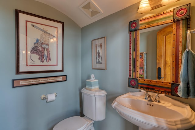 21 Canada Vista Dr, Sandia Park, NM 87047 - half bathroom with vaulted ceiling, visible vents, toilet, and a sink