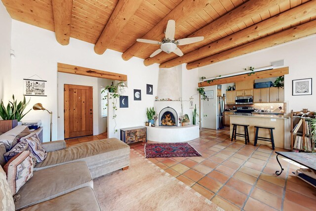 living room featuring wood ceiling, beamed ceiling, and light tile patterned floors