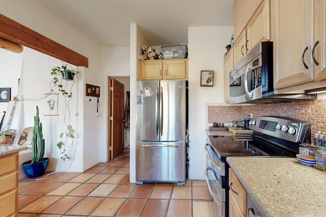 kitchen with stainless steel appliances, backsplash, light brown cabinets, light tile patterned floors, and light stone countertops