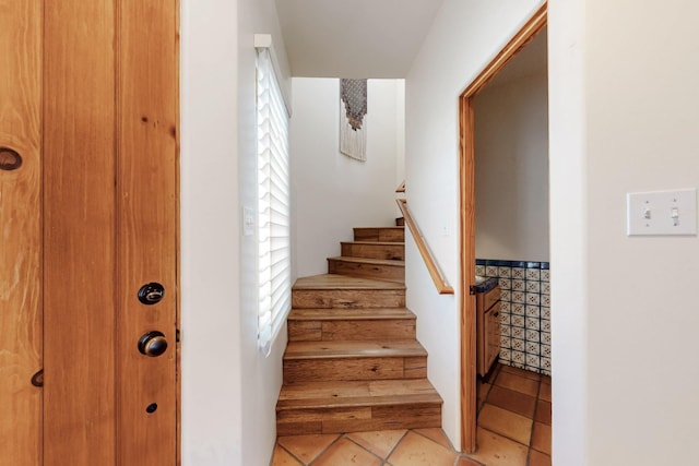 stairs featuring tile patterned flooring