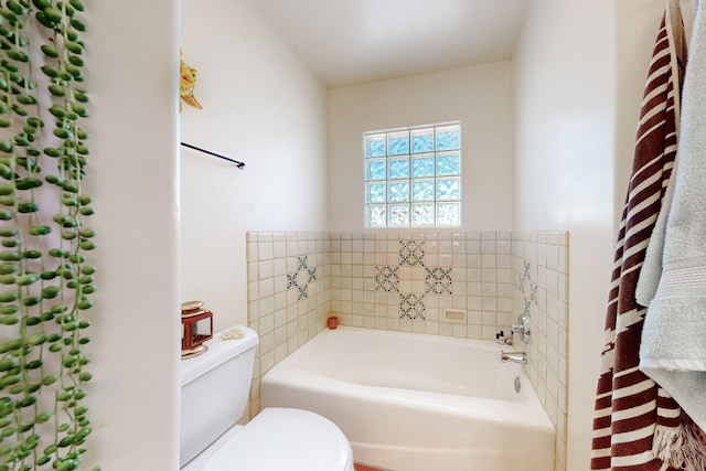 bathroom featuring a bath and toilet
