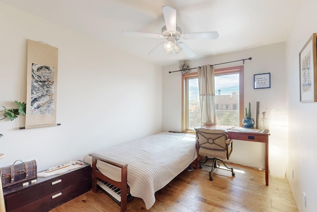 bedroom with light wood-type flooring and ceiling fan