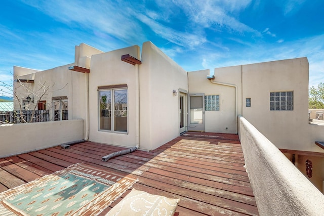 rear view of property featuring stucco siding