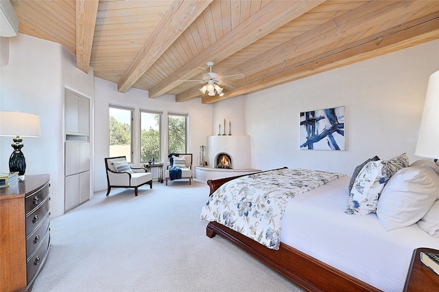 carpeted bedroom with wood ceiling, a ceiling fan, and beam ceiling