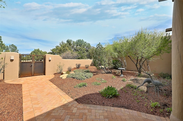 view of yard featuring a gate and a fenced backyard