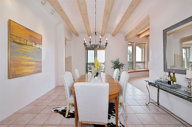 dining room featuring beamed ceiling, a chandelier, and light tile patterned floors