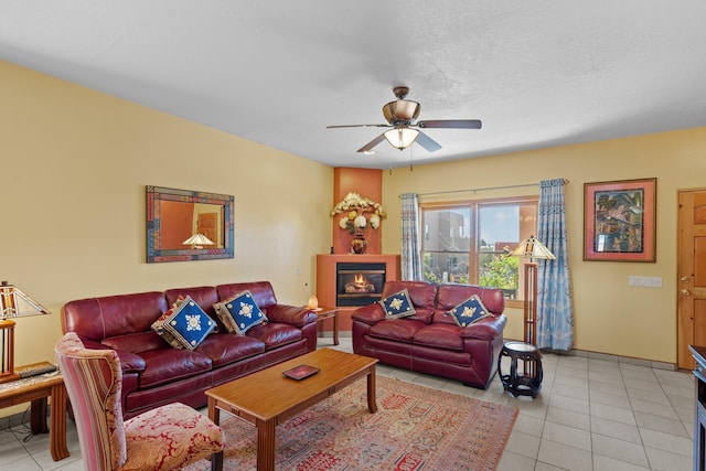 living room featuring ceiling fan and light tile patterned flooring