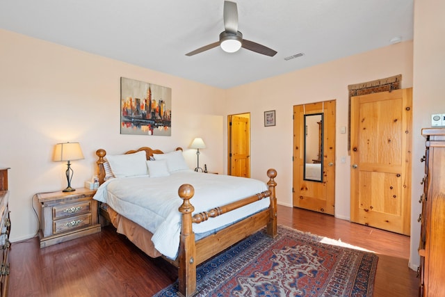bedroom featuring ceiling fan, wood finished floors, and visible vents