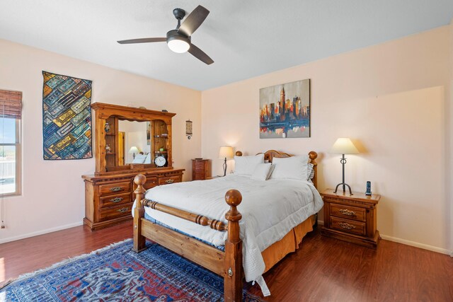 bedroom featuring wood finished floors, baseboards, and ceiling fan