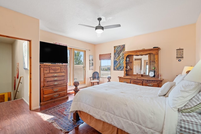 bedroom with wood finished floors, baseboards, and ceiling fan