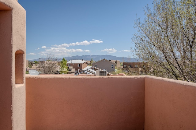 balcony featuring a residential view and a mountain view