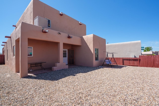 back of property featuring stucco siding, a patio area, and fence