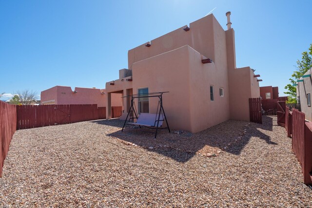 back of property featuring a fenced backyard and stucco siding