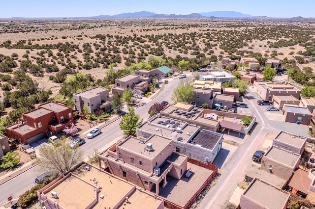 drone / aerial view featuring a desert view and a mountain view