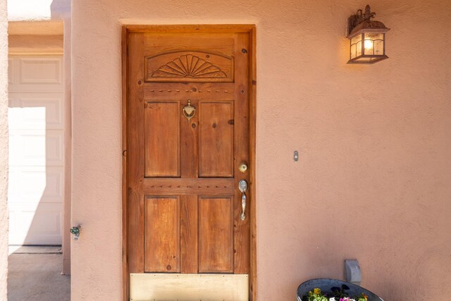 entrance to property with stucco siding