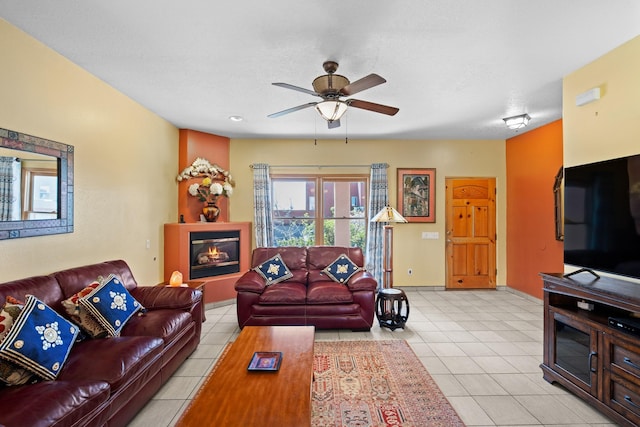 tiled living room with baseboards and ceiling fan