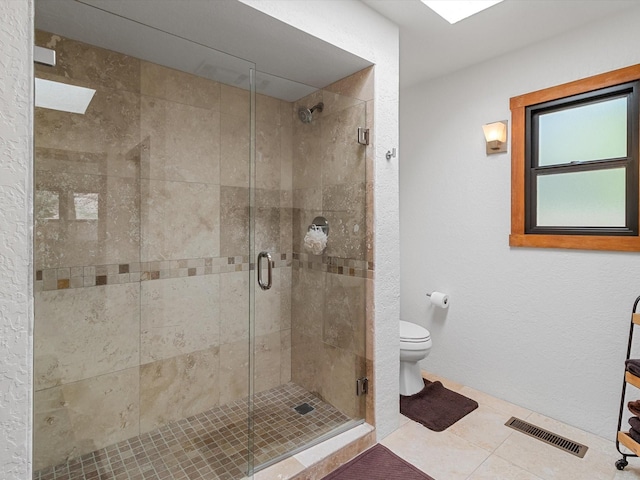 full bath with a stall shower, visible vents, tile patterned flooring, and toilet