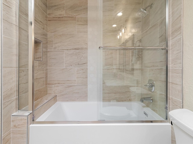 full bathroom with combined bath / shower with glass door and toilet