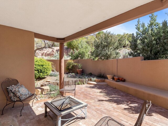 view of patio / terrace with fence and a fire pit