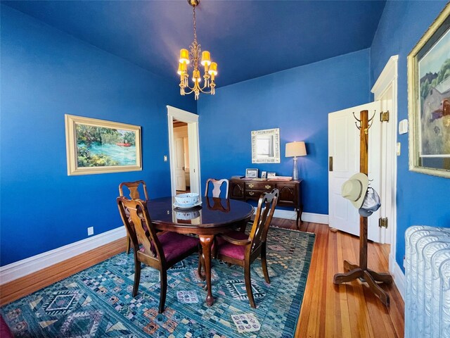 1607 8th St, Las Vegas, NM 87701 - dining room with wood finished floors, baseboards, and an inviting chandelier