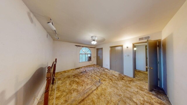 unfurnished bedroom featuring visible vents and carpet