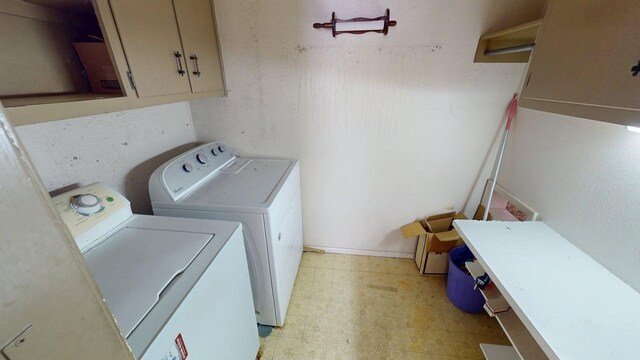 laundry area featuring washing machine and clothes dryer, light floors, and laundry area