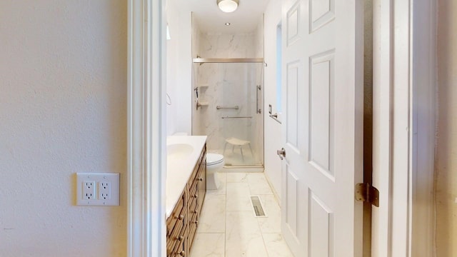full bath with a marble finish shower, vanity, a textured wall, toilet, and visible vents