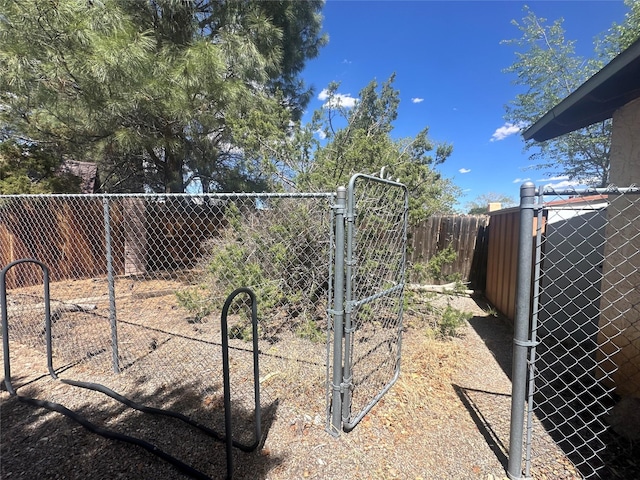 view of yard featuring fence and a gate