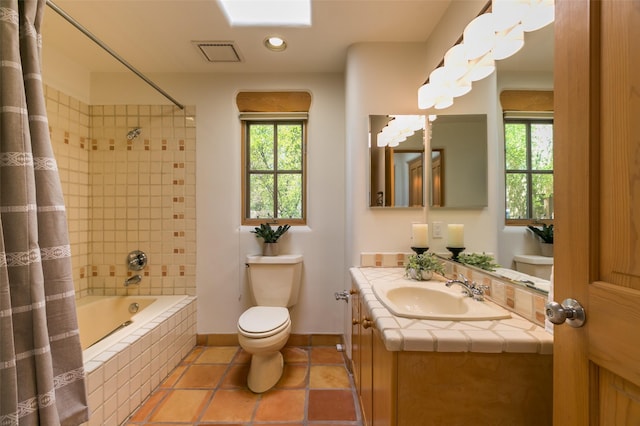 bathroom with tiled shower / bath combo, visible vents, a wealth of natural light, and toilet