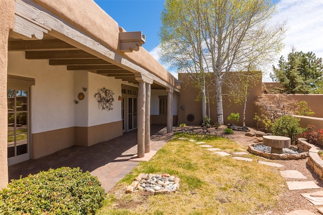 view of yard featuring fence and a patio