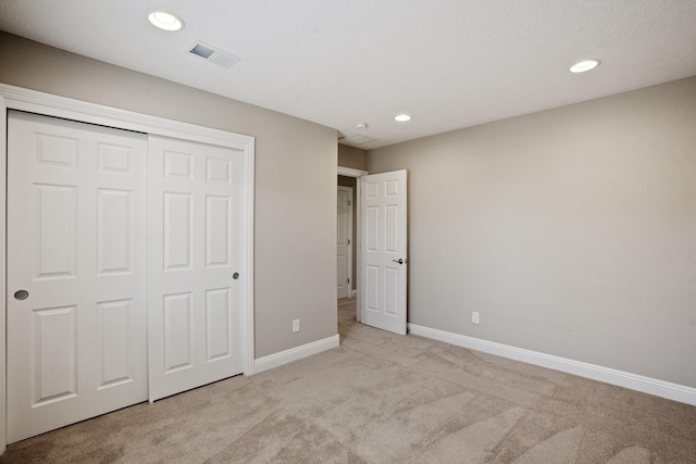 unfurnished bedroom with recessed lighting, visible vents, carpet, and baseboards