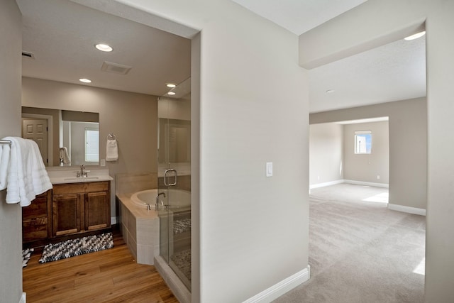 full bathroom with recessed lighting, a shower stall, vanity, visible vents, and baseboards