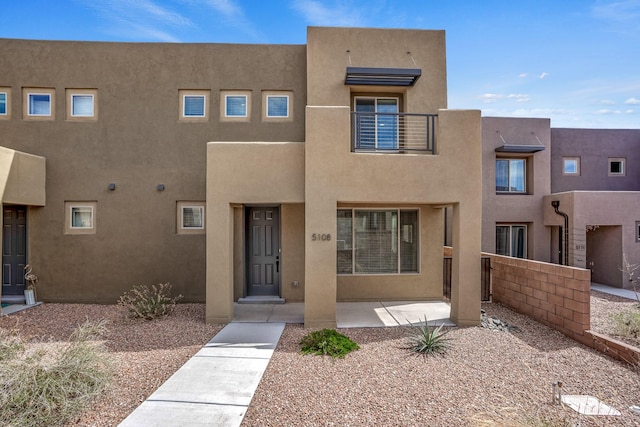 adobe home featuring stucco siding