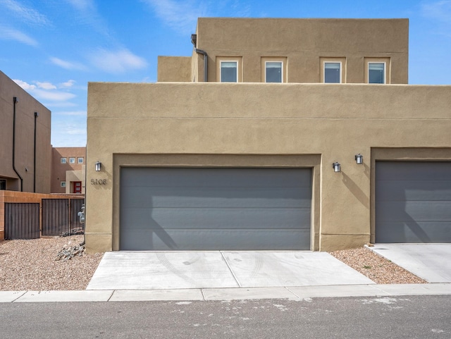 view of front of home with driveway, a garage, and stucco siding