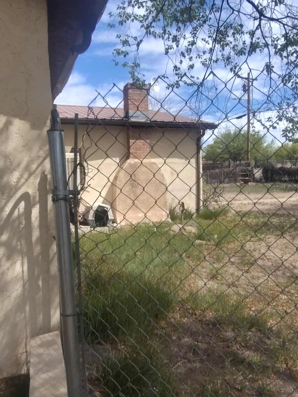 view of side of property featuring a chimney and fence