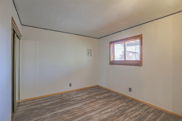 unfurnished room featuring wood finished floors and baseboards