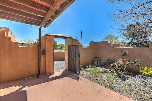 view of patio with a gate and fence