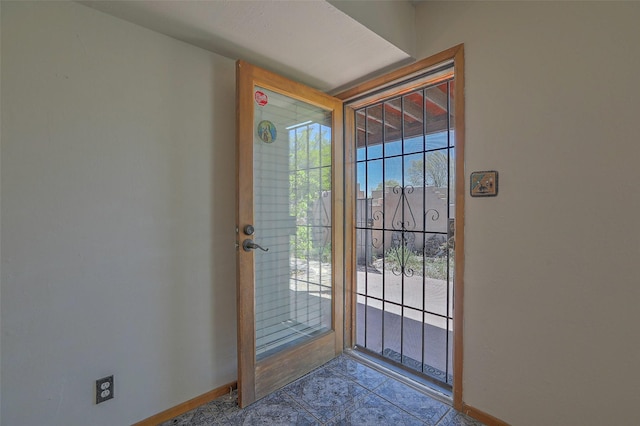 doorway featuring baseboards
