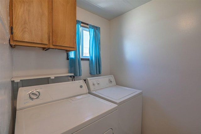 laundry area with washing machine and dryer and cabinet space