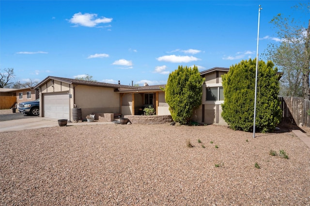 2416 Avenida De Las Campanas, Santa Fe, NM 87507 - view of front of home with stucco siding, an attached garage, and concrete driveway