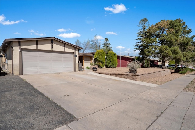 2416 Avenida De Las Campanas, Santa Fe, NM 87507 - view of front of house with stucco siding, concrete driveway, and an attached garage