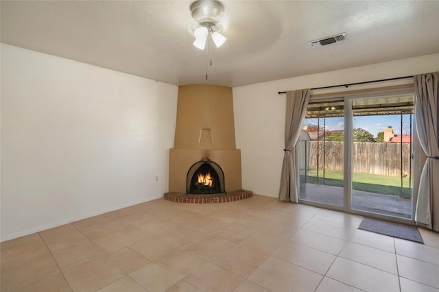 2416 Avenida De Las Campanas, Santa Fe, NM 87507 - unfurnished living room featuring a ceiling fan, a large fireplace, and light tile patterned floors