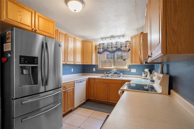 2416 Avenida De Las Campanas, Santa Fe, NM 87507 - kitchen with white appliances, a sink, a textured ceiling, light countertops, and light tile patterned floors