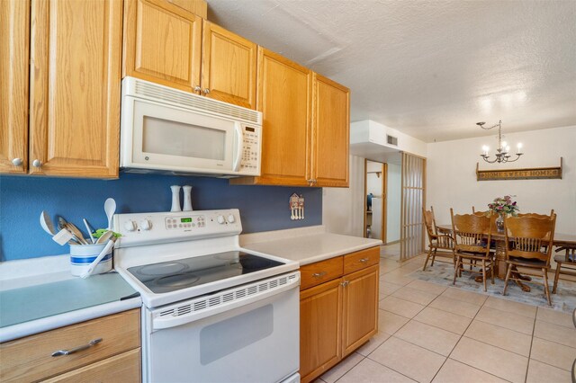 2416 Avenida De Las Campanas, Santa Fe, NM 87507 - kitchen featuring white appliances, light countertops, a chandelier, a textured ceiling, and light tile patterned floors