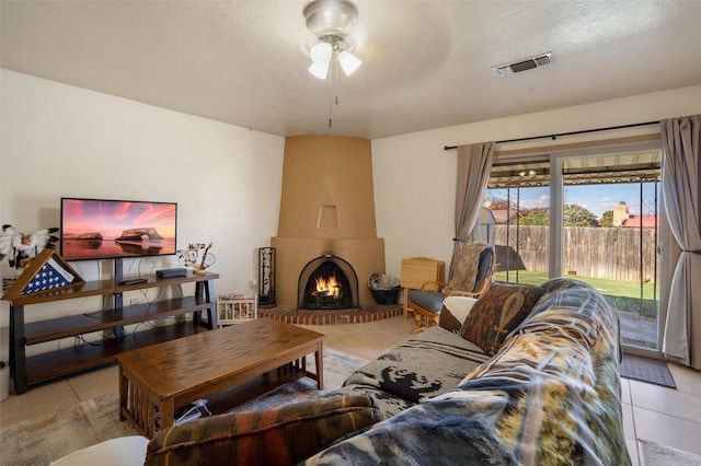 2416 Avenida De Las Campanas, Santa Fe, NM 87507 - living area featuring tile patterned floors, ceiling fan, and a large fireplace