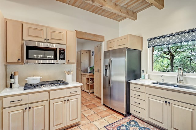 kitchen featuring wooden ceiling, light brown cabinets, stainless steel appliances, a sink, and light tile patterned flooring