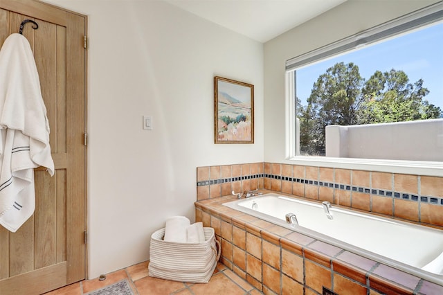 bathroom featuring a garden tub and tile patterned flooring