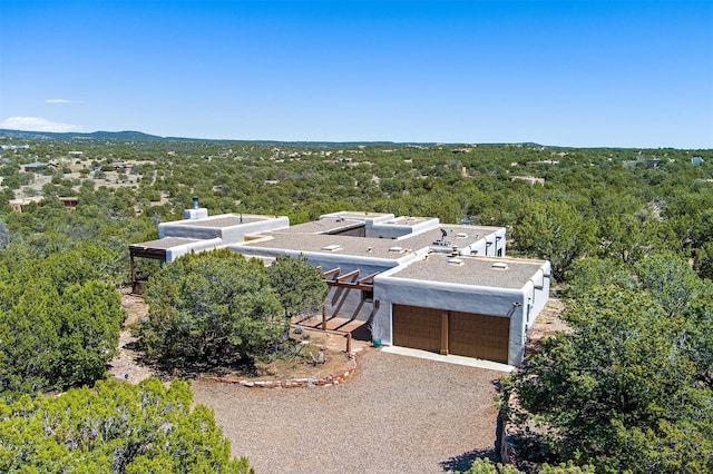 drone / aerial view featuring a view of trees